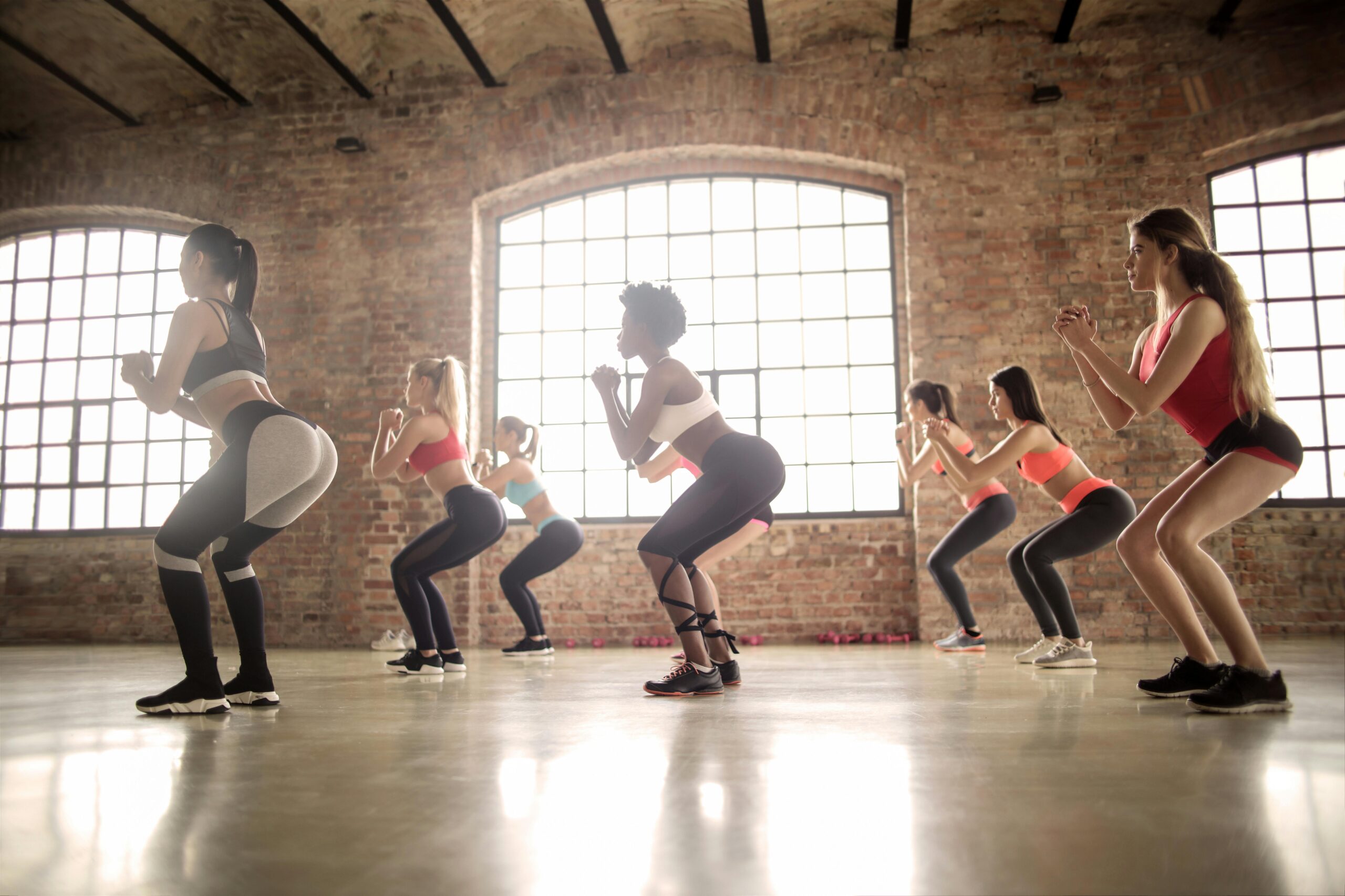 Women doing squats to improve glutes